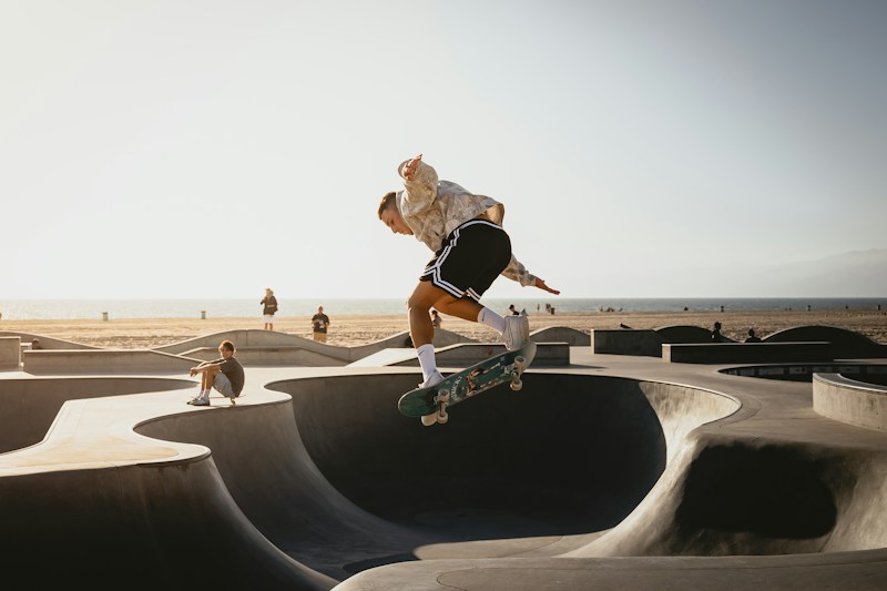 Skateboarder riding a concrete bowl transition