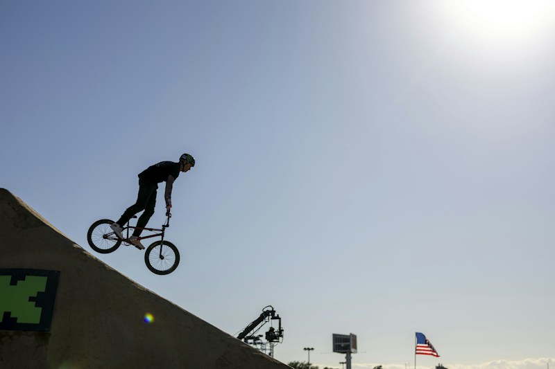 Rider filming a jump off a ramp on a phone